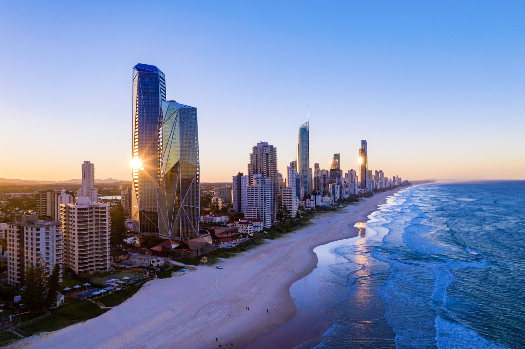 A stretch of buildings along a beach front