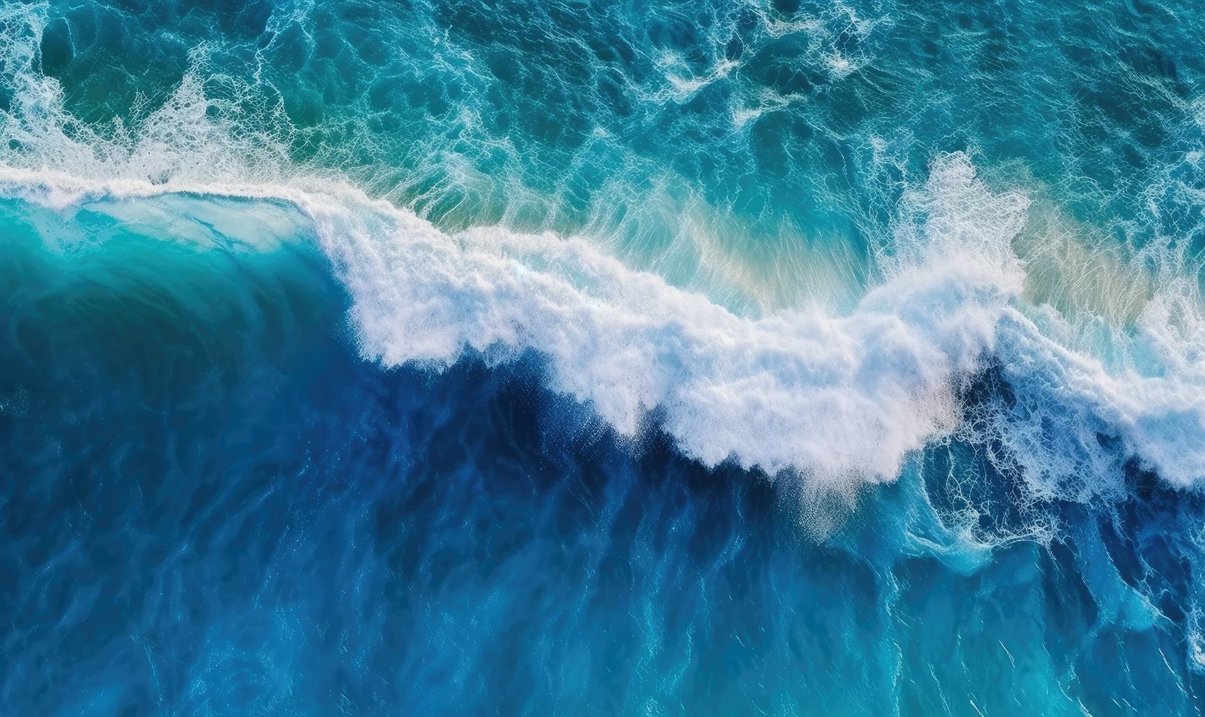 Bright blue ocean wave crashing against another wave
