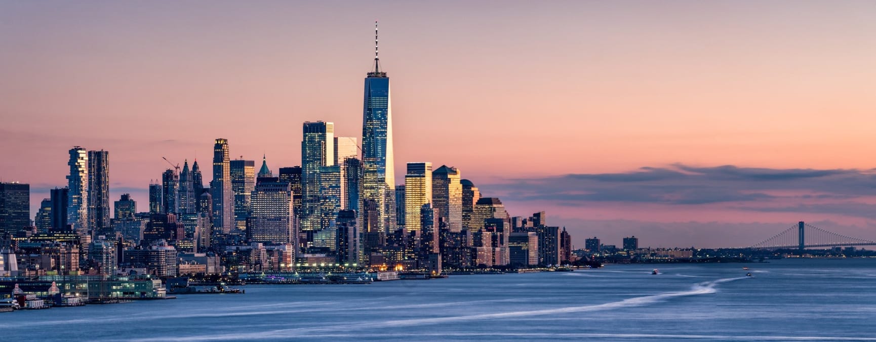 Manhattan at sunset with Brooklyn bridge in background