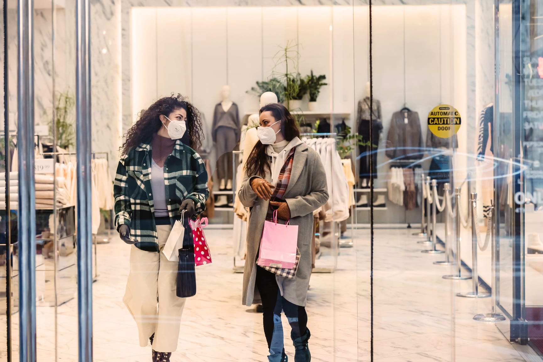 Two ladies walking out of retail store