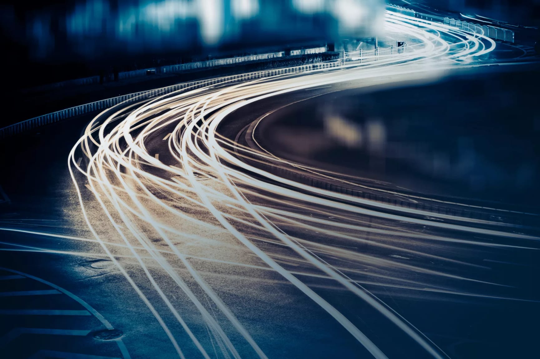 Timelapse of blurred white car lights on a dark road