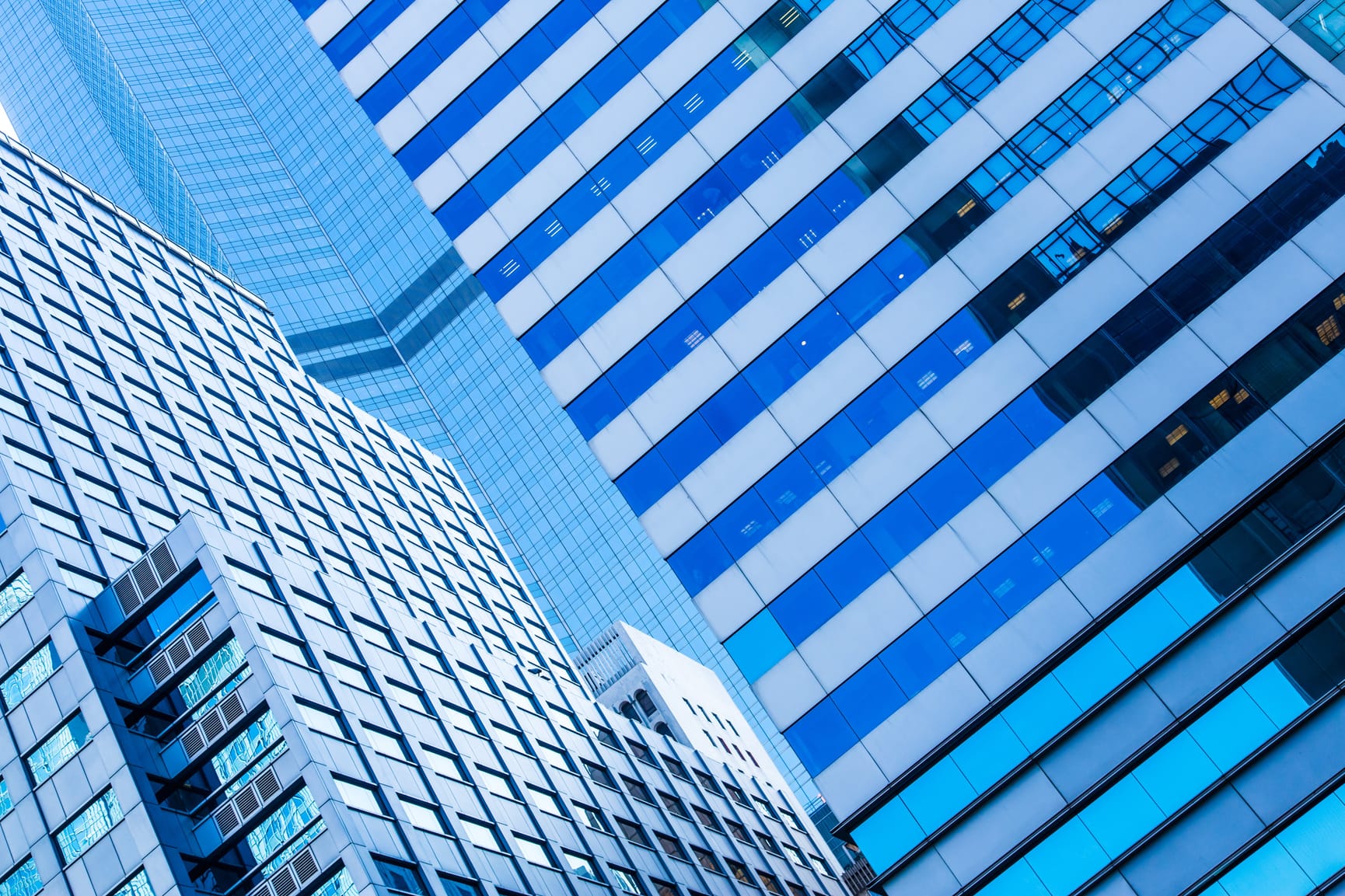 Angled blue skyscrapers photographed at a dutch angle.