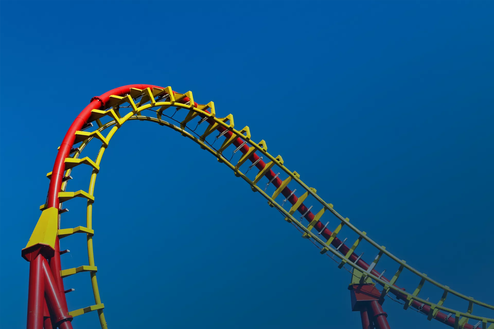 A section of a red and yellow roller coaster 