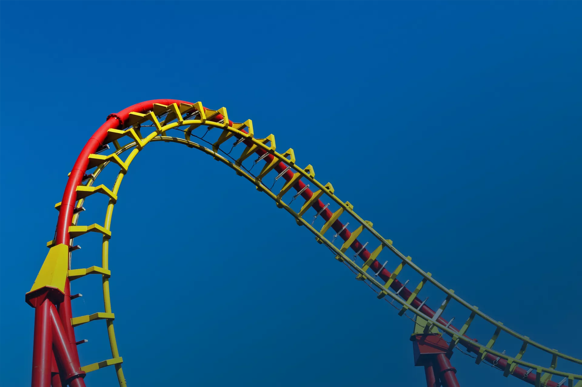 A section of a red and yellow roller coaster 